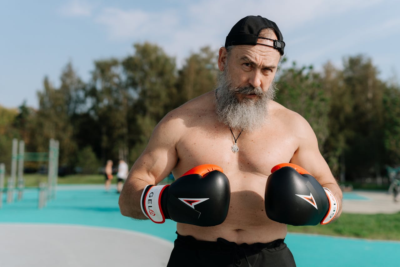 Elderly man engaged in outdoor boxing workout for a healthy lifestyle.